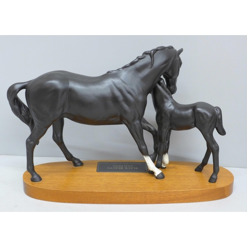 609 - A Beswick figure group, Black Beauty and Foal