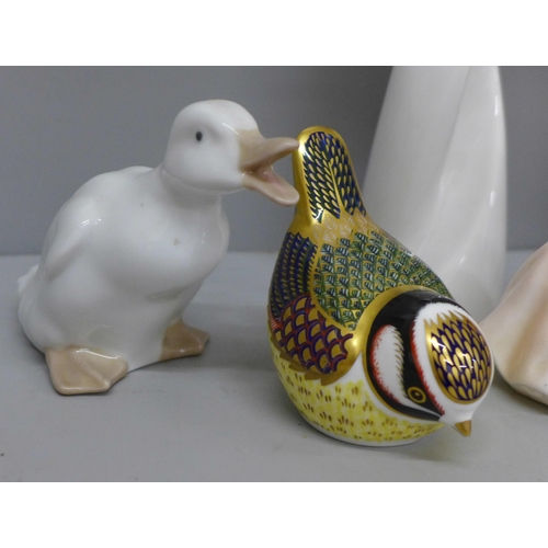 642 - A Royal Crown Derby bird paperweight with gold stopper, a Coalport figure and five Nao figures