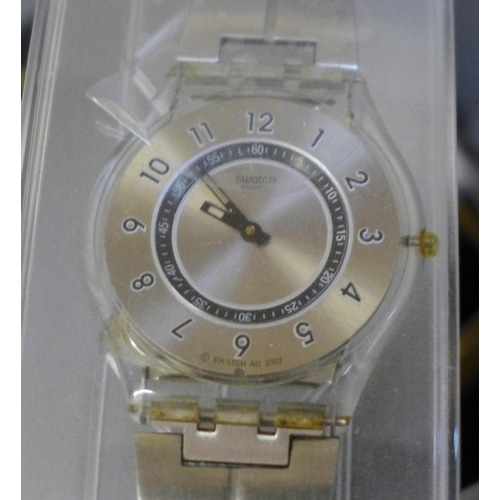 650 - A Swatch Skin wristwatch, two other wristwatches and a collection of costume jewellery