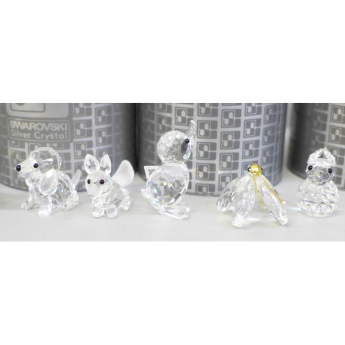 704 - A collection of eight Swarovski animals and four boxed, including four birds on a branch