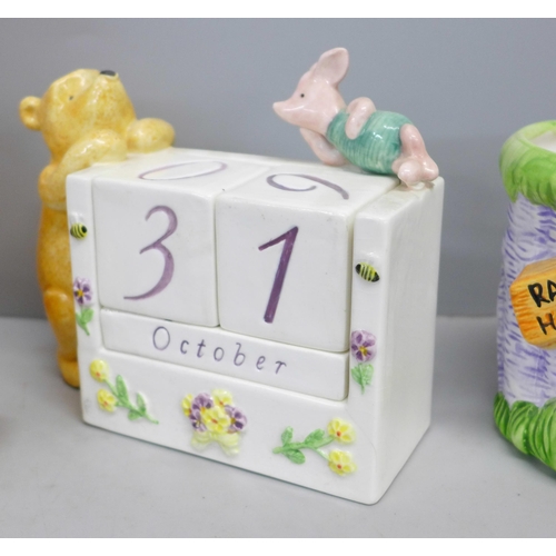 761 - A Winnie The Pooh money box, perpetual calendar and novelty mug