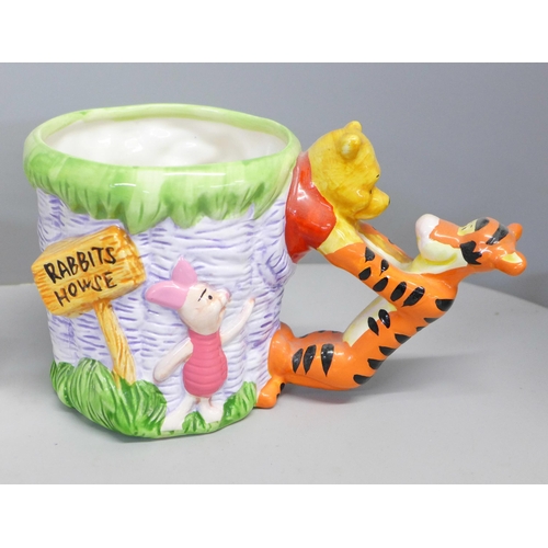 761 - A Winnie The Pooh money box, perpetual calendar and novelty mug