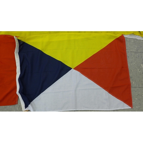 777 - A collection of flags; a large Navy white ensign flag, 4.6m x 2.1m, a Union Jack with broad arrow on... 