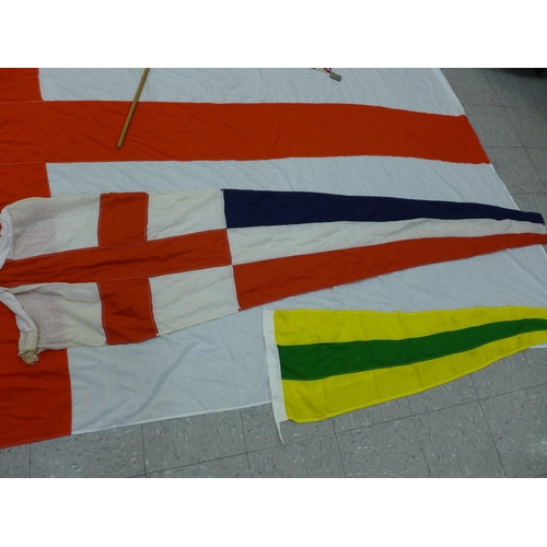 777 - A collection of flags; a large Navy white ensign flag, 4.6m x 2.1m, a Union Jack with broad arrow on... 