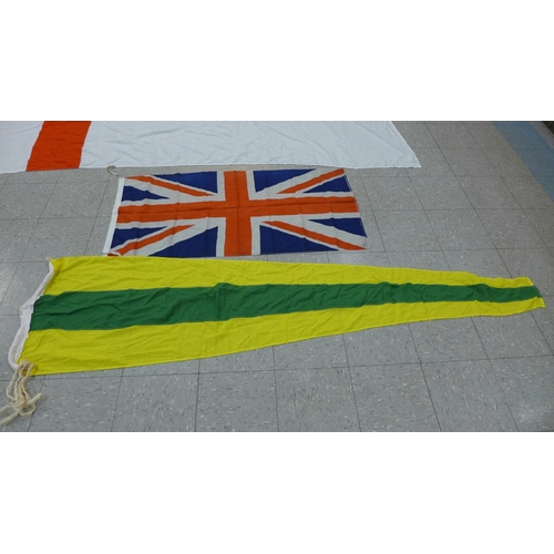 777 - A collection of flags; a large Navy white ensign flag, 4.6m x 2.1m, a Union Jack with broad arrow on... 