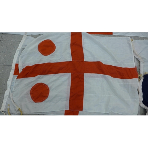 777 - A collection of flags; a large Navy white ensign flag, 4.6m x 2.1m, a Union Jack with broad arrow on... 