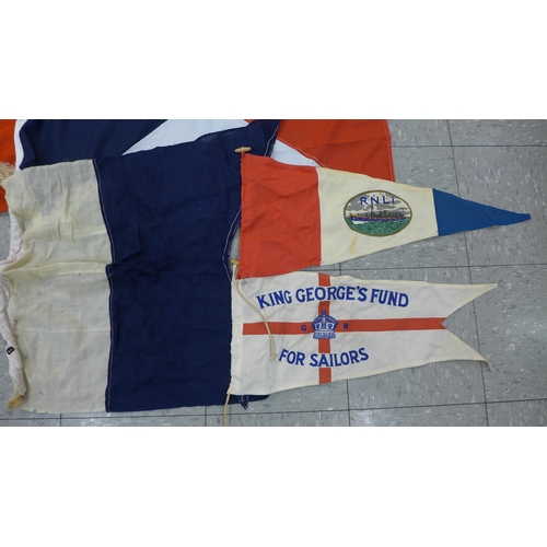 777 - A collection of flags; a large Navy white ensign flag, 4.6m x 2.1m, a Union Jack with broad arrow on... 