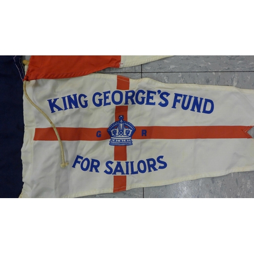 777 - A collection of flags; a large Navy white ensign flag, 4.6m x 2.1m, a Union Jack with broad arrow on... 