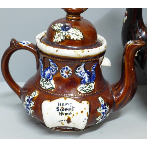 785 - A large bargeware teapot, spout restored and internal crack, one smaller teapot, largest dated 1908