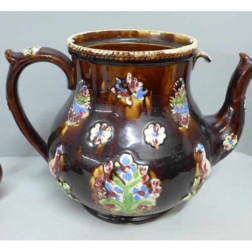 785 - A large bargeware teapot, spout restored and internal crack, one smaller teapot, largest dated 1908