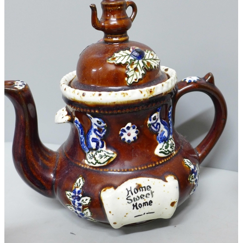 785 - A large bargeware teapot, spout restored and internal crack, one smaller teapot, largest dated 1908