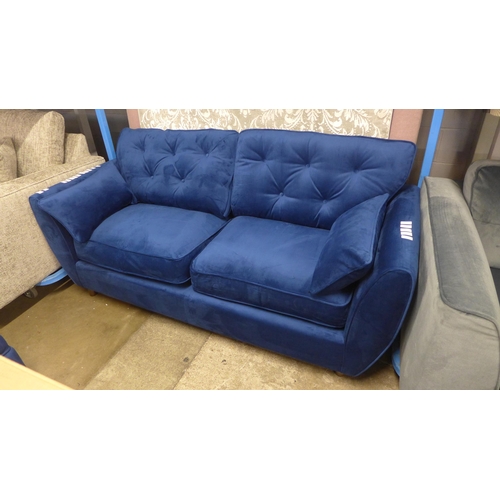 1319 - A Hoxton blue velvet upholstered three seater sofa RRP £799