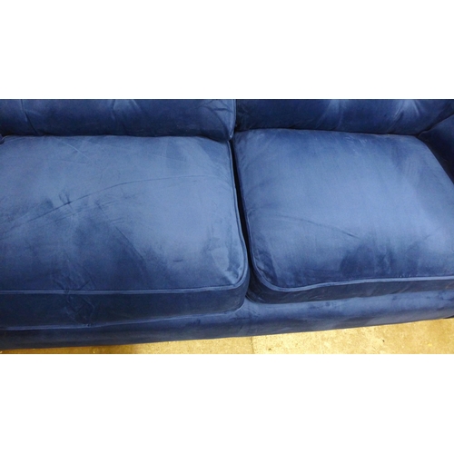 1320 - A Hoxton blue velvet upholstered three seater sofa RRP £799