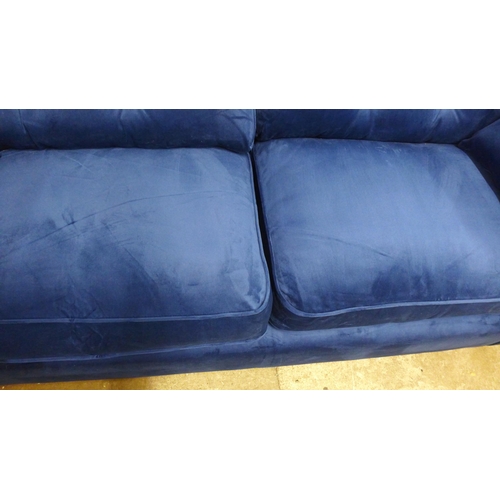 1321 - A Hoxton blue velvet upholstered three seater sofa RRP £799