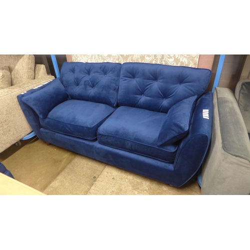 1325 - A Hoxton blue velvet upholstered three seater sofa RRP £799