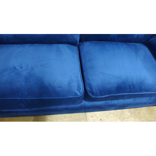 1325 - A Hoxton blue velvet upholstered three seater sofa RRP £799