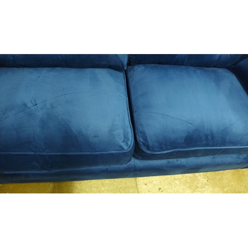 1326 - A Hoxton blue velvet upholstered three seater sofa RRP £799