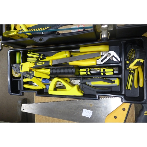 2023 - A Wickes tool box inc. a spirit level, a saw, screwdrivers, tape measures, a stapler, a craft knife,... 