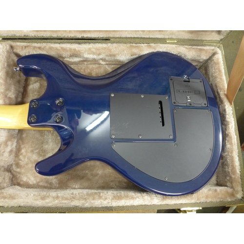 2142 - A Line 6 Variax electric guitar in a plush protective hard case and a Line 6 JTV Variax cabled power... 