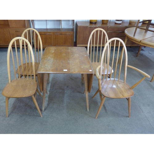 11 - An Ercol Blonde elm and beech Windsor drop-leaf table and four Ercol Quaker chairs