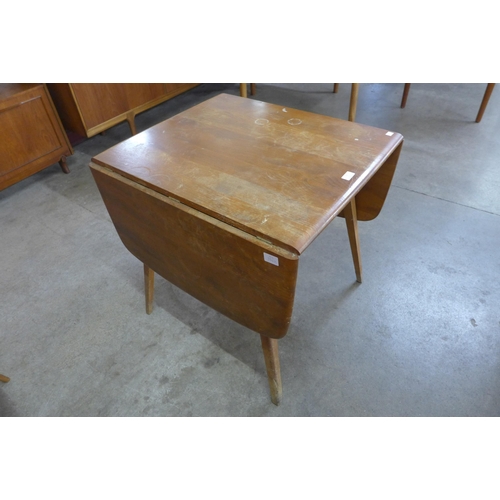 11 - An Ercol Blonde elm and beech Windsor drop-leaf table and four Ercol Quaker chairs