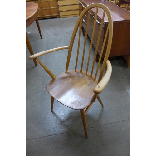 11 - An Ercol Blonde elm and beech Windsor drop-leaf table and four Ercol Quaker chairs