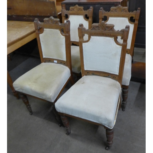 111 - A set of four Victorian carved oak dining chairs