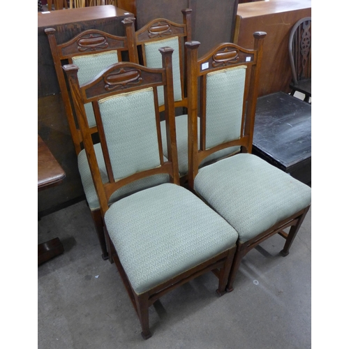 116 - A set of four Arts and Crafts oak dining chairs