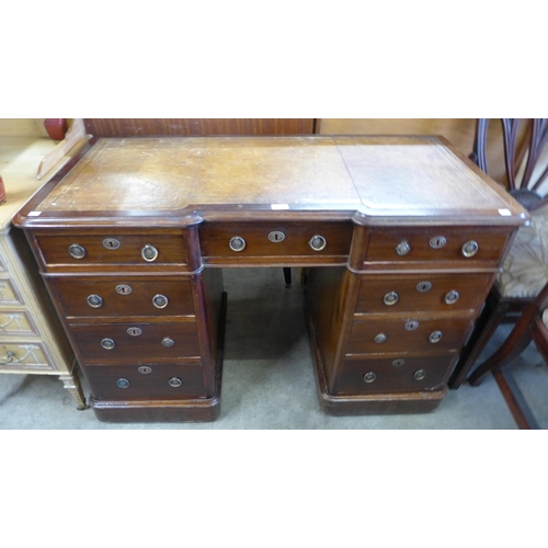 130 - A Victorian mahogany and tan leather topped inverted breakfront pedestal desk