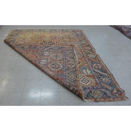 136 - An eastern terracotta ground rug, 350 x 270cms