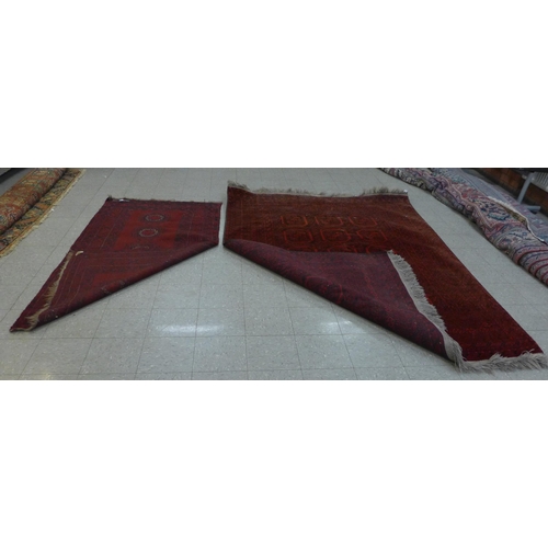 137 - Two eastern red ground rugs, 288 x 202cms and 225 x 118cms