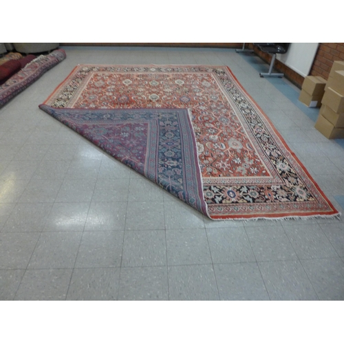 139 - A large eastern red ground rug, 425 x 317cms