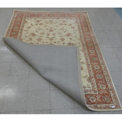 140 - A Chinese cream ground part silk rug, 273 x 183cms