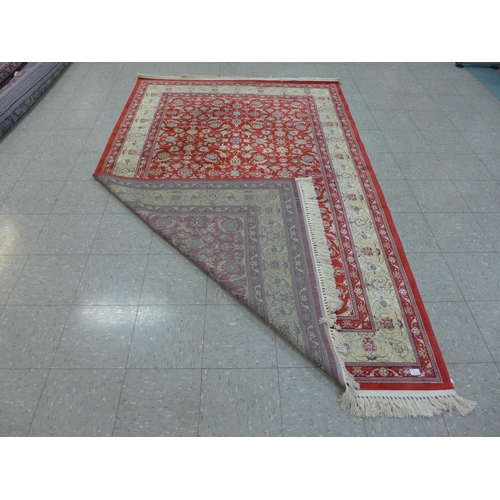 140A - A red ground rug, 287 x 176cms