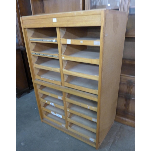 170 - An oak and plywood sixteen drawer shop cabinet