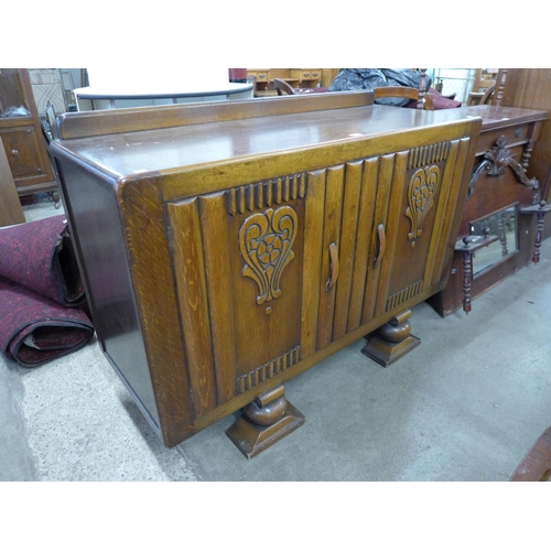 207 - An early 20th Century carved oak sideboard