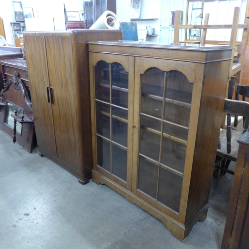 209 - A walnut two door bookcase and a fitted tallboy