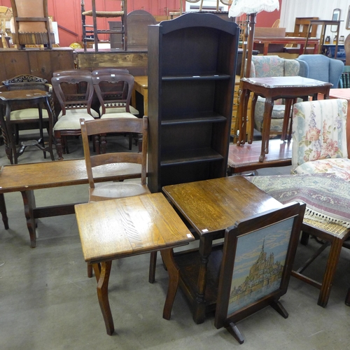 227 - A Victorian elm kitchen chair, two oak occasional tables, a firescreen and an oak open bookcase