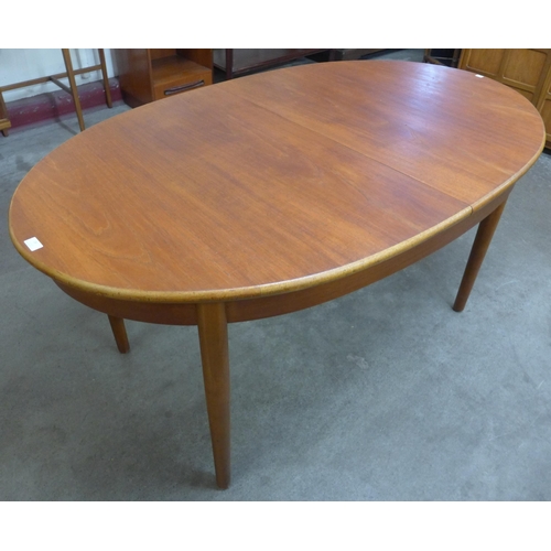 24 - A teak oval extending dining table