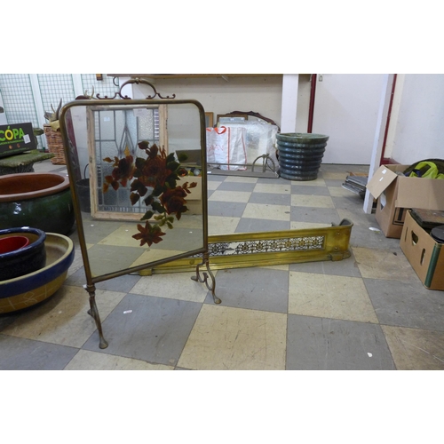 253 - A Victorian brass fender and an Art Nouveau brass and mirrored glass fire screen