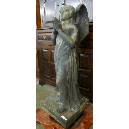 255 - A large reconstituted stone figure of an angel