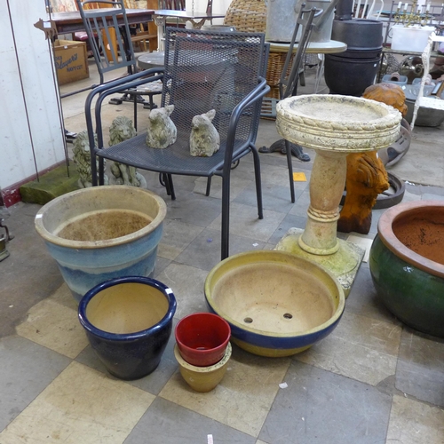 256 - A sandstone bird bath, three terracotta planters, a pair of small concrete rabbits and a pair of met... 