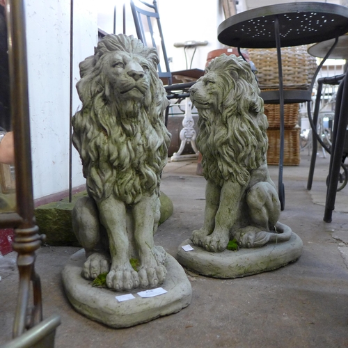 258 - A pair of concrete figures of seated lions