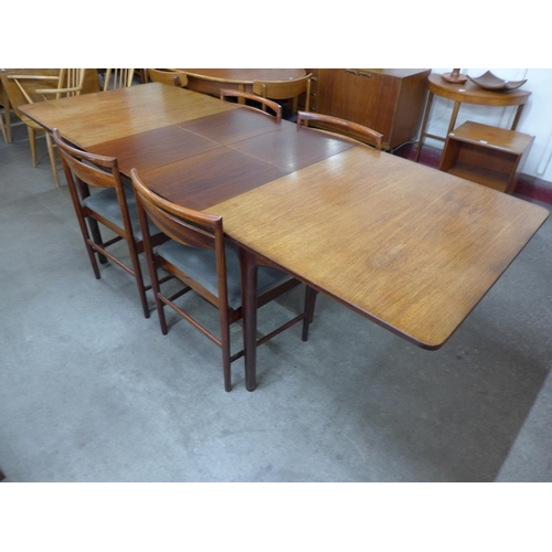 26B - A McIntosh rosewood extending T3 model dining table and four chairs, designed by Tom Robertson, CITE... 