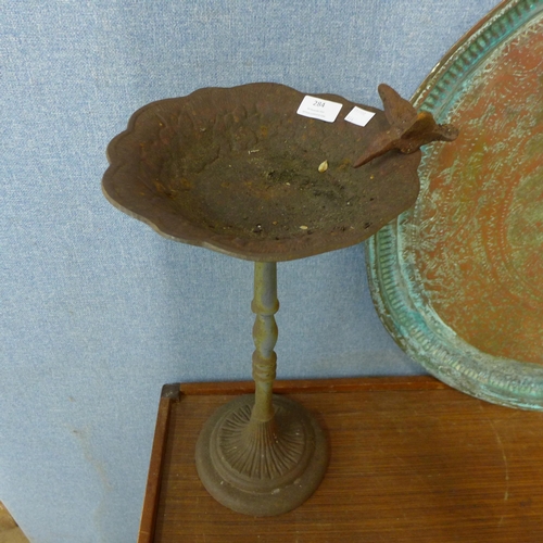 284 - A small cast iron bird bath and a copper charger