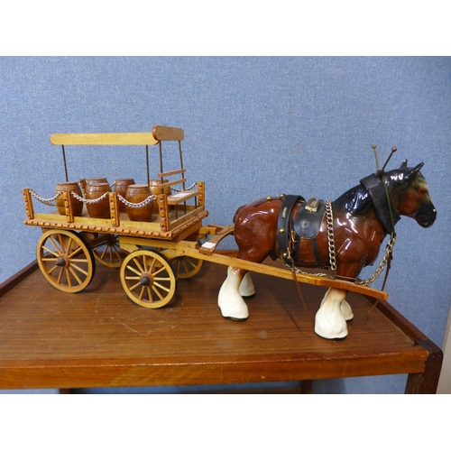 324 - A porcelain Shire horse with wooden cart