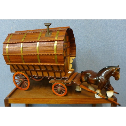 325 - A porcelain Shire horse with wooden Romany Rose trailer