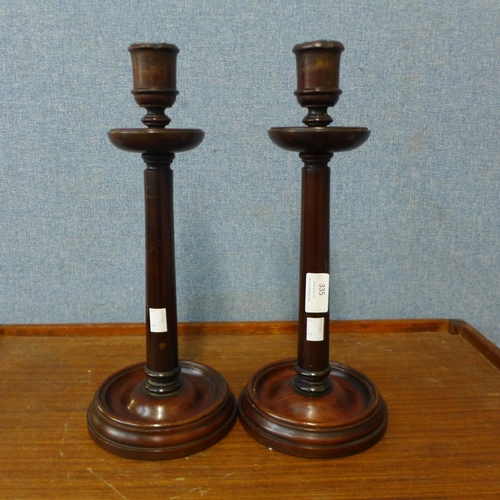 335 - A pair of late Victorian mahogany candlesticks