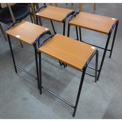 50 - A set of four teak and and black tubular steel stools