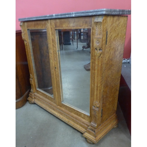 69 - A Victorian maple and marble topped two door pier cabinet